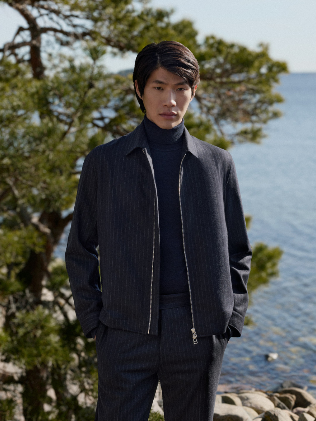 man in dark bomber jacket